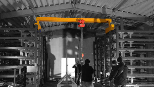Storage warehouse rack system with overhead stacking crane